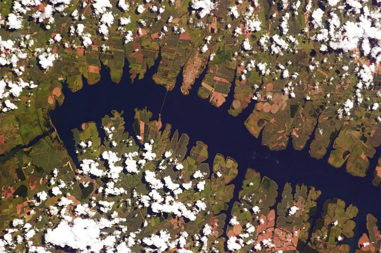 Pereira Barreto: The area around Perereira Barreto in Brazil, about 400 miles north of São Paolo, was originally settled in the 1920s by Japanese immigrants who worked on coffee and sugar planation along the Rio Tietê. But in the 1990s, the river was dammed to create a hydroelectric power plant, flooding and permanently submerging many farms and even a suspension bridge across the Tietê. Today there’s a new bridge, and from this angle, the body of water looks like a millipede.