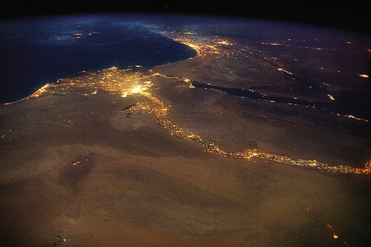 The End: The Nile, draining out into the Mediterranean. The bright lights of Cairo announce the opening of the north-flowing river’s delta, with Jerusalem’s answering high beams to the northeast. This 4,258 mile braid of human life, first navigated end-to-end in 2004, is visible in a single glance from space