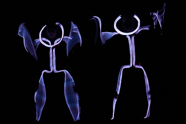 Jasmine Orpilla and Drew Thataussie dance as graph people who lose their heads.