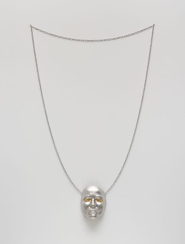 Gillian Wearing, "Me As Necklace" (2014). Metal chain and painted mask.