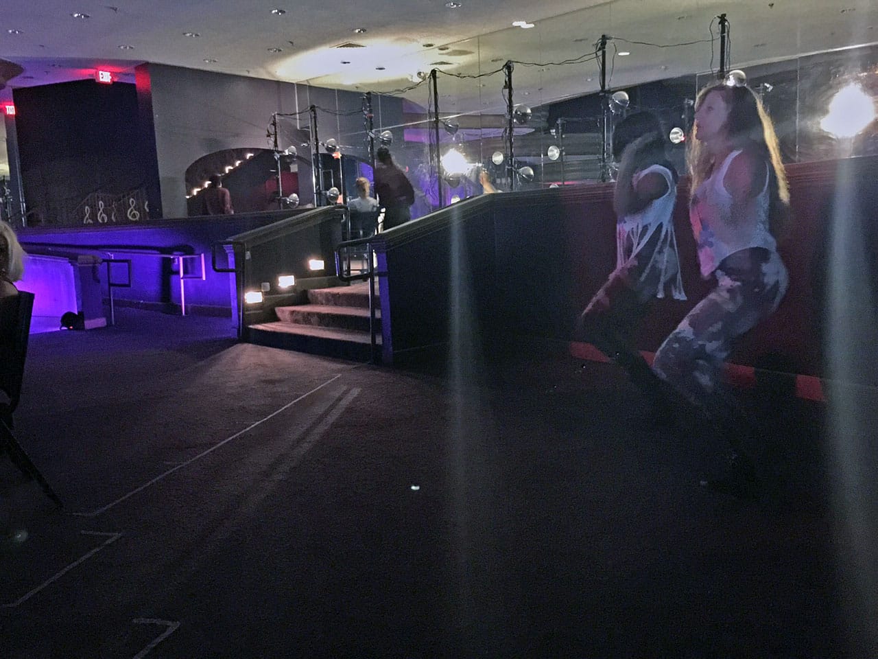 Dancers perform on various levels as audience members are moved.