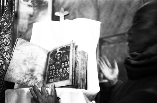Jerusalem, December 2012; "In the Ethiopian church near Damascus Gate, the guardian shows an ancient version of the Bible. In the Christian community of Jerusalem between Damascus Gate and Jaffa Gate, the Catholic, Orthodox, Egyptians and Ethiopians are divided between small spaces and winding paths."