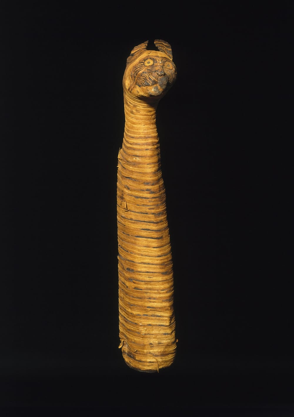 Cat Mummy. From Egypt. Third Intermediate Period to Late Period, 780-390 B.C.E. Linen, animal remains, 23 13/16 x 4 3/4 x 5 1/2 in. (60.5 x 12.1 x 14 cm). Brooklyn Museum; Charles Edwin Wilbour Fund, 37.1988E  