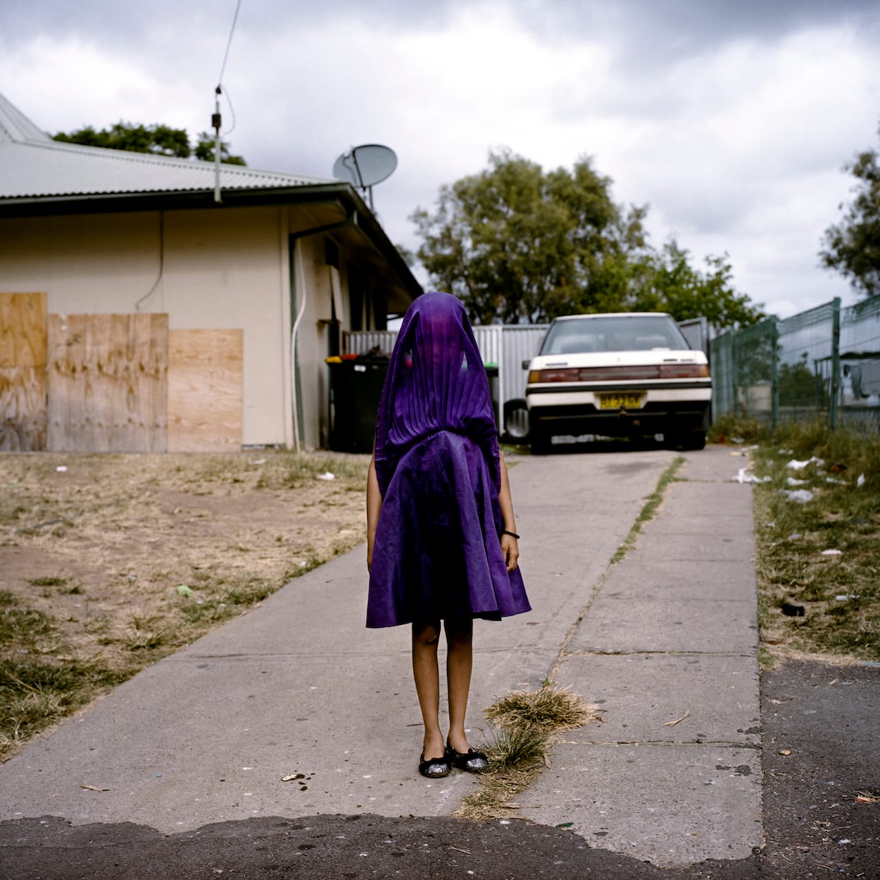 First Prize Portraits Category, Singles Raphaela Rosella, Australia, Oculi Moree, New South Wales, Australia Caption: Laurinda waits in her purple dress for the bus that will take her to Sunday School. She is among the many socially isolated young women in disadvantaged communities in Australia facing entrenched poverty, racism, trans-generational trauma, violence, addiction, and a range of other barriers to health and well-being.