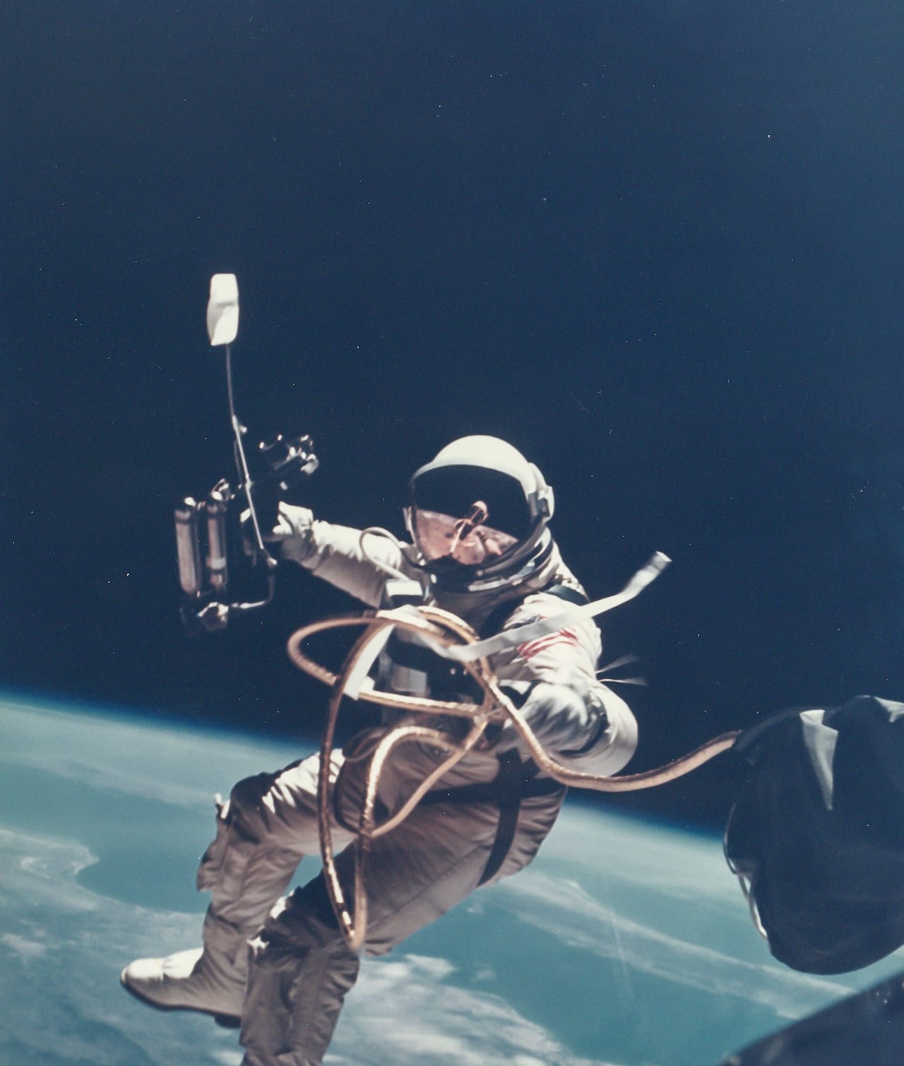 James McDivitt First US Spacewalk - Ed White’s EVA over New Mexico, Gemini 4, 3 June 1965 Vintage chromogenic print flush-mounted to original card, 20 x 25.5cm, image 18 x 15.3cm, [NASA  negative number S-65-30433A] Provenance: The personal collection of Ed White , Heritage Auctions, Sale 6082, lot Captivated by the experience of his spacewalk, Ed White resisted repeated calls from Houston to get  back to the craft: Est. £800-1,200 Reproduction, © Bloomsbury Auctions