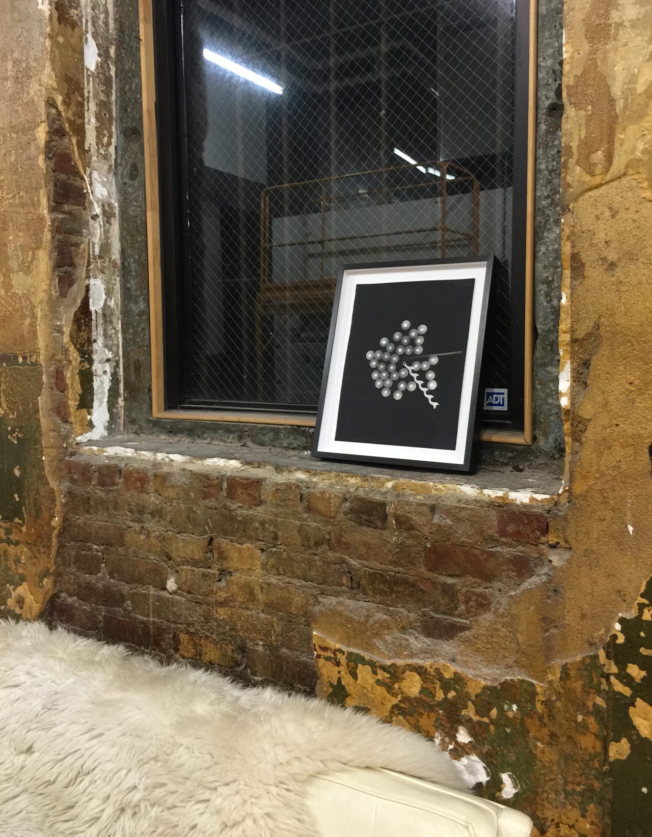 Installation view of Emily Roysdon's Untitled (Photogram clock) (2014) in the office space at Participant Inc, New York, NY.