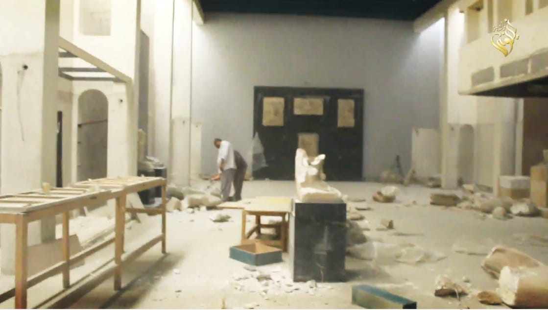 Destructing in the Mosul Museum with some remaining items in the background.