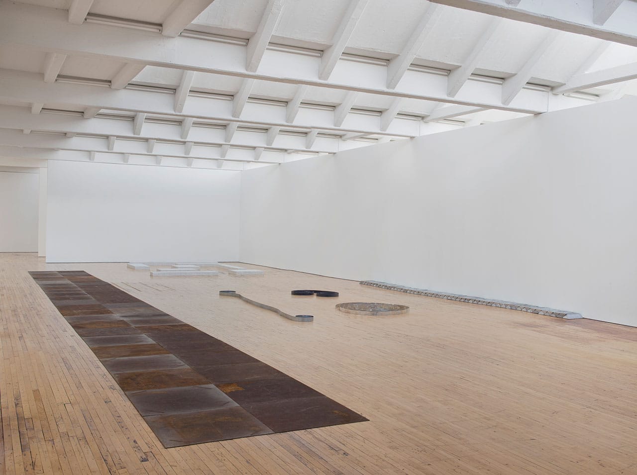 Installation view, 'Carl Andre: Sculpture as Place, 1958–2010,' showing "46 Roaring Forties" (1988) and "Zinc Ribbon" (1969), at Dia:Beacon, Riggio Galleries, Beacon, NY, May 5, 2014–March 9, 2015 (all photos by Bill Jacobson, © Carl Andre/Licensed by VAGA, New York, courtesy Dia Art Foundation, New York)