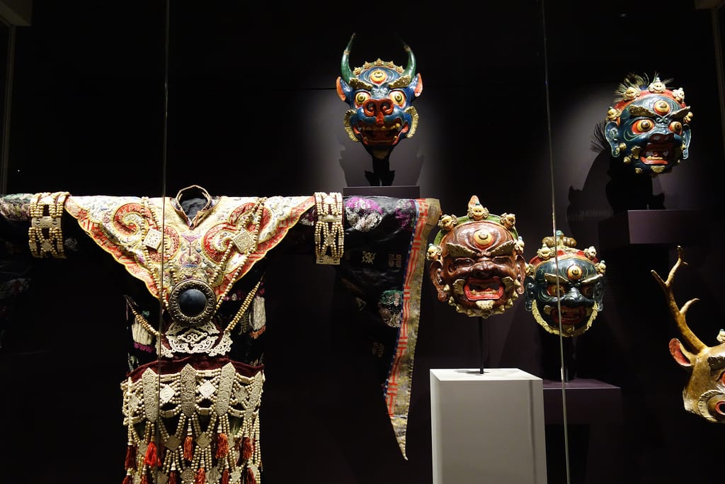 A costume and masks used in the Cham dances of Tibet