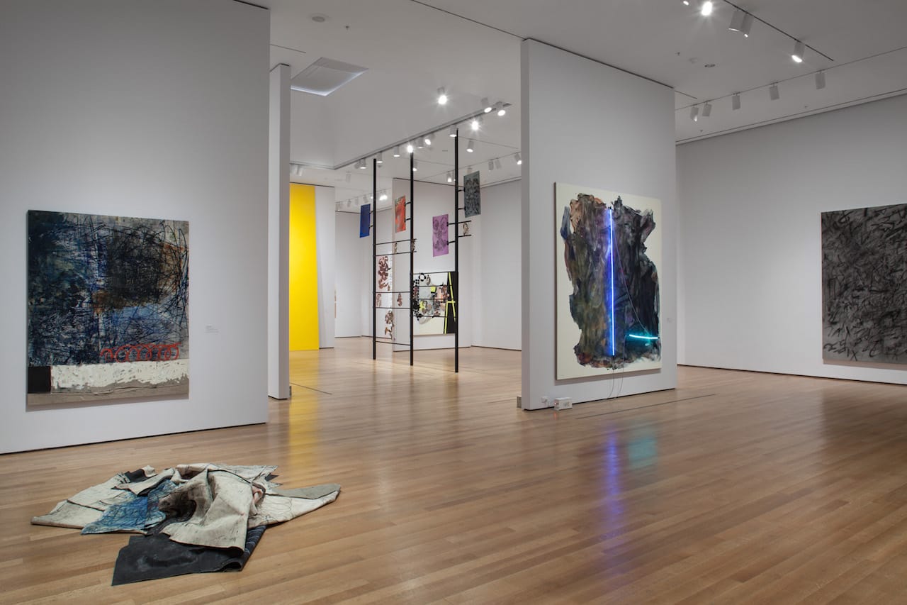 Installation view of 'The Forever Now: Contemporary Painting in an Atemporal World' at The Museum of Modern Art, New York, with Oscar Murillo's unstretched paintings at left (photo by John Wronn; © 2014 The Museum of Modern Art)