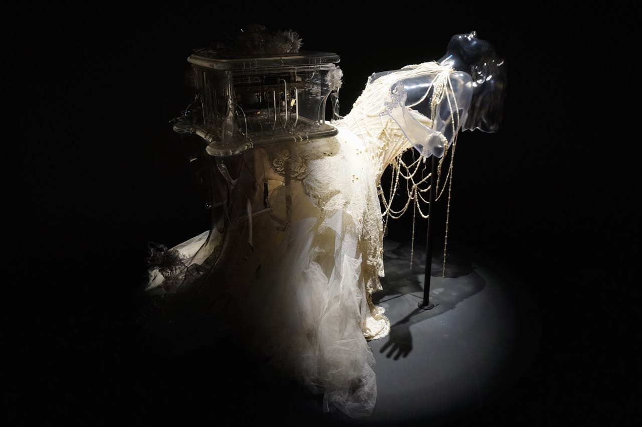 Alexander McQueen, "Pagan Poetry" Dress (2001), and Matthew Barney, 'Verspertine' Music Box (2001) and 'Vespertine Live' Shoes (2001) (photo by Jillian Steinhauer/Hyperallergic)