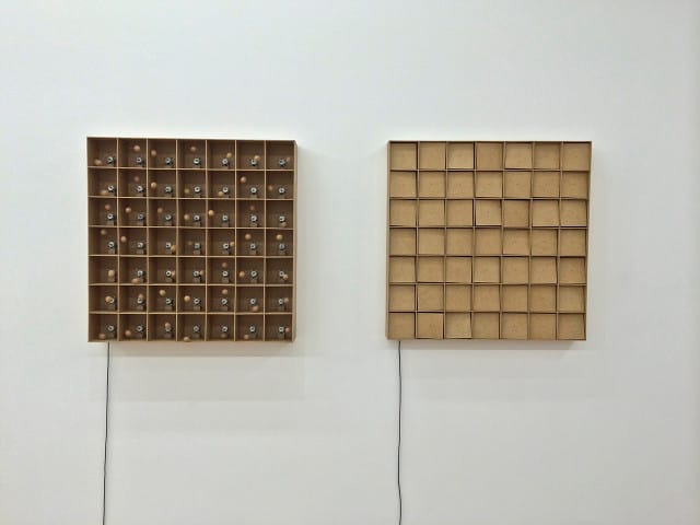 Zimoun, Left: "49 prepared dc-motors, cork balls, mdf boxes 13x13x13cm" (2015), Right: "49 prepared dc-motors, mdf elements, mdf boxes 13x13x13cm" (2015