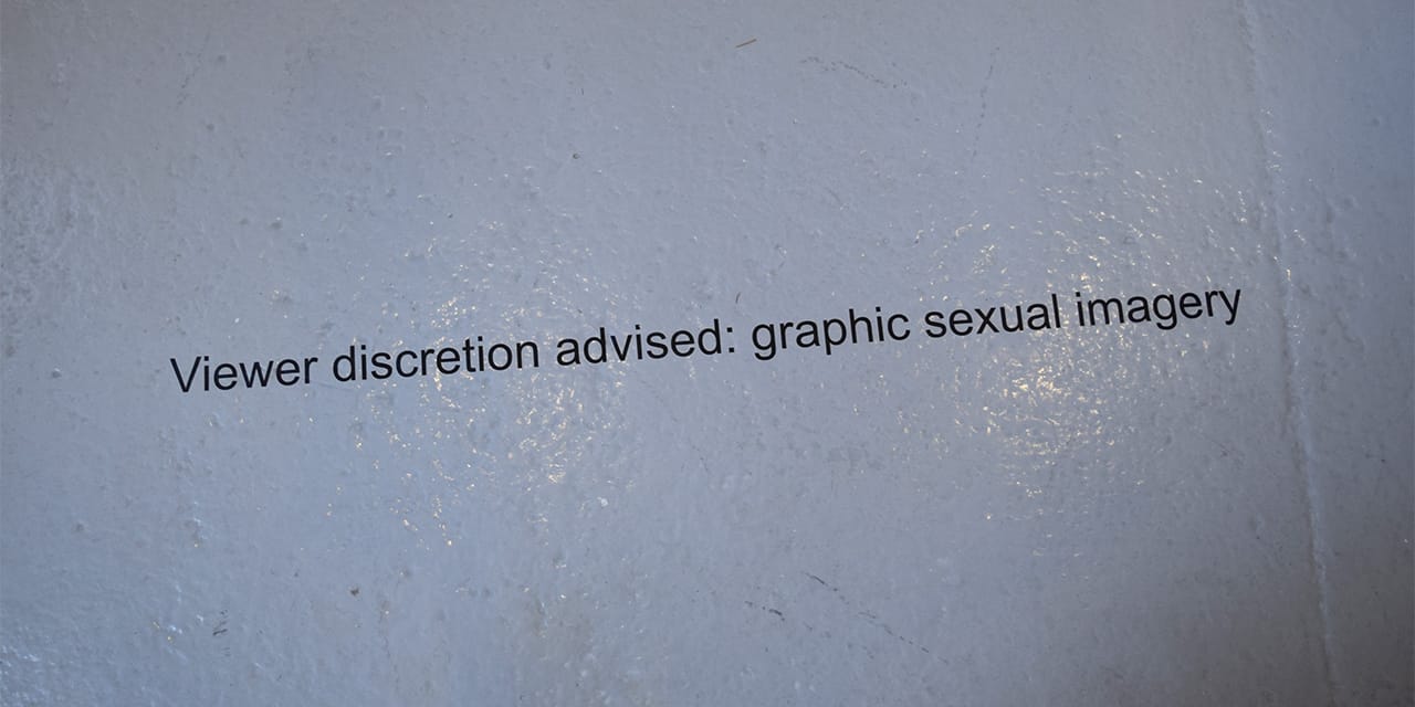 Cautionary signage outside the Mendes Wood DM booth