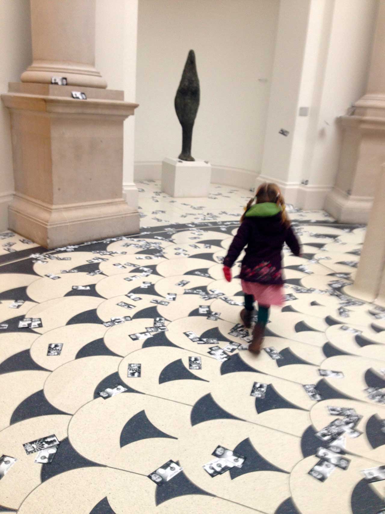 An image from Liberate Tate's money drop protest last February in the Tate Britain Liberate Tate members dropping fake money at Tate Britain (photo by Cassie Packard for Hyperallergic)