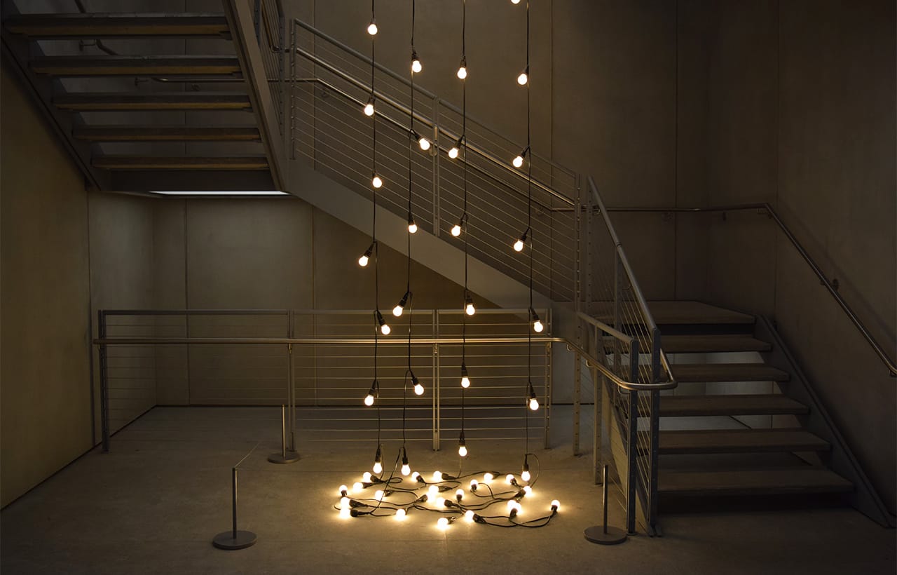 Félix González-Torres's "Untitled (America)" (1994) hangs down five flights of stairs, pooling in the building's basement