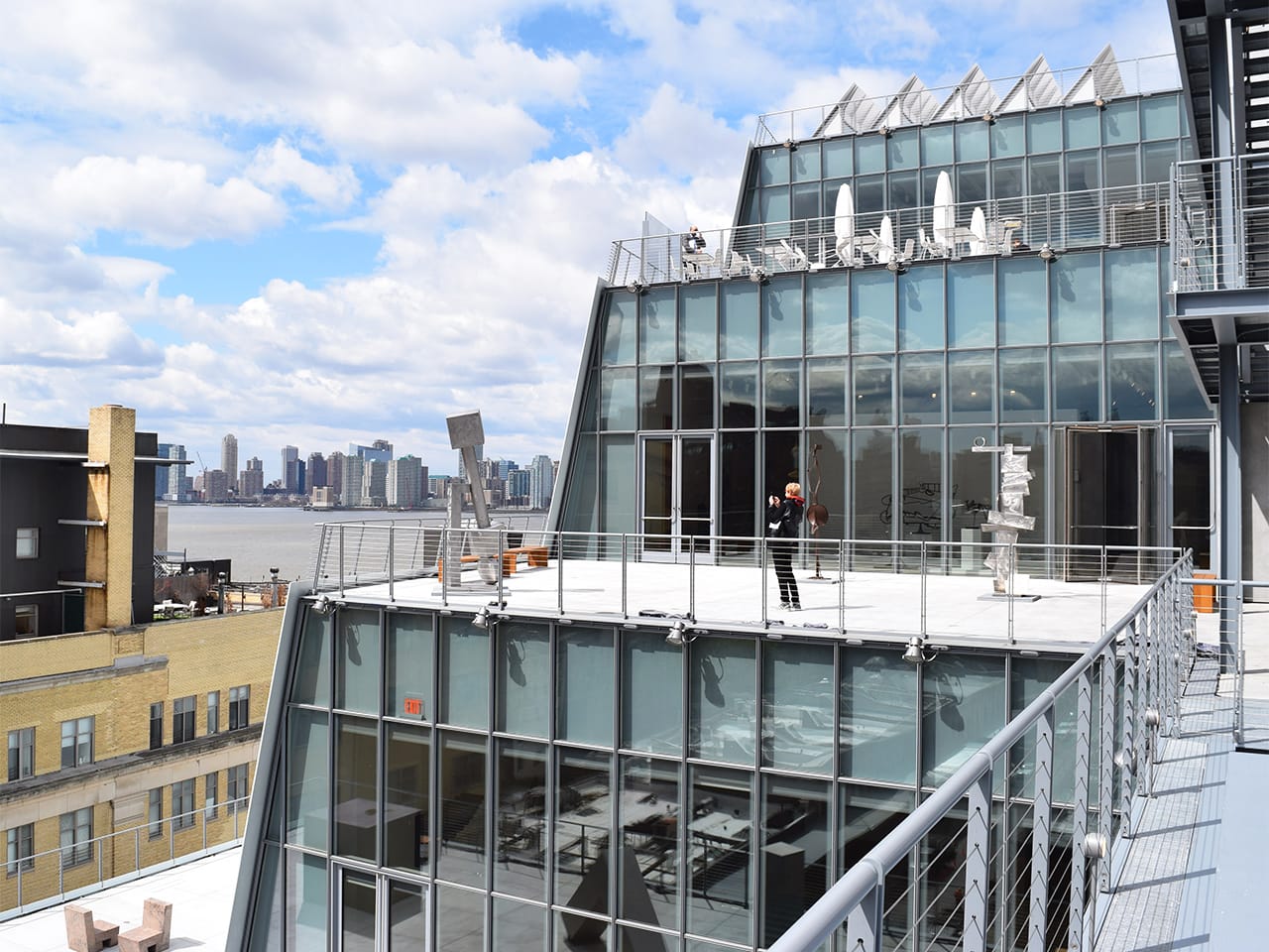 The building's west façade features a series of terraces