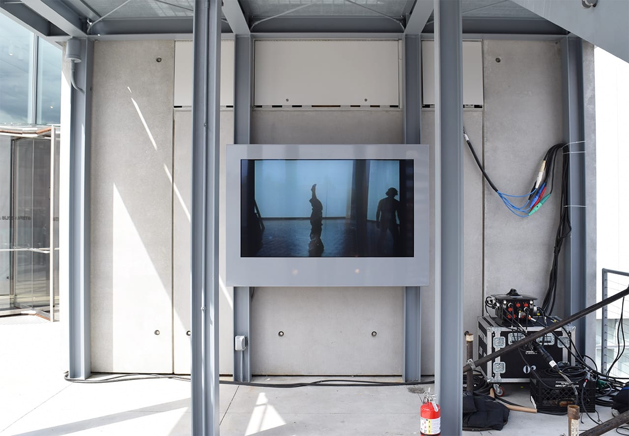 Video of an Yvonne Rainer performance at the Whitney Museum in 1970 plays on one of the terraces