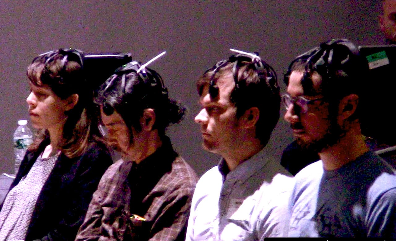 Four volunteer performers wearing custom Cogniotics EEG headsets