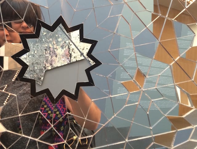 The layers of mirrors seem to encourage selfies, but the selfies appear in fractures and refractions.