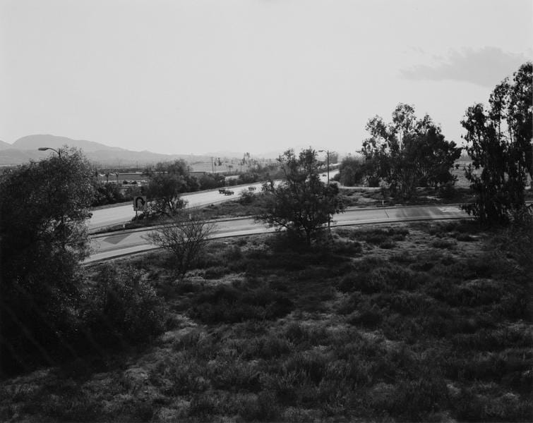 Robert Adams, "Looking toward Los Angeles, Interstate 10, west edge of Redlands, California" (1982), Gelatin silver print, Image: 9 x 11 1/4 inches (via matthewmarks.com)