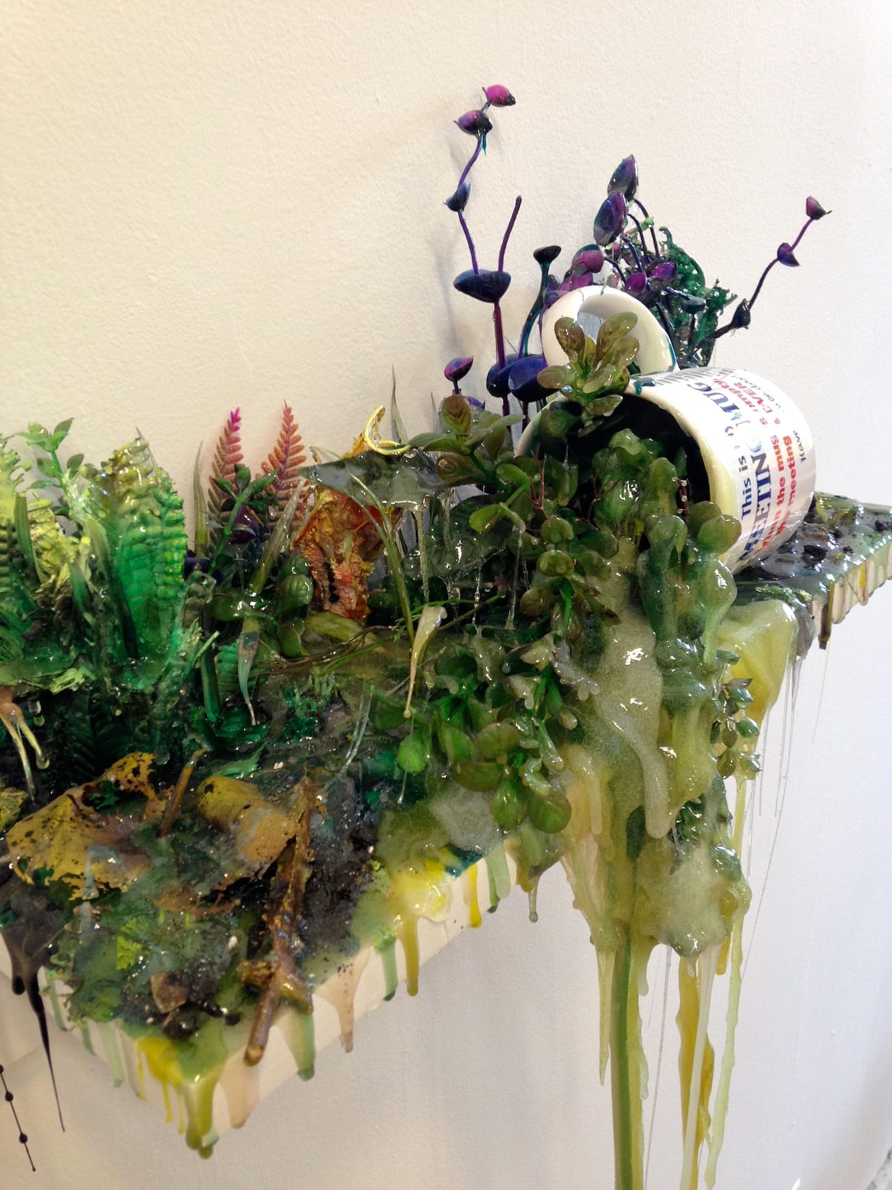 Jon Duff, "Meeting Cup" (2015), polyurethane resin, acrylic, mug, and plywood, 18" x 12" x 6" (photo by Jillian Steinhauer for Hyperallergic)