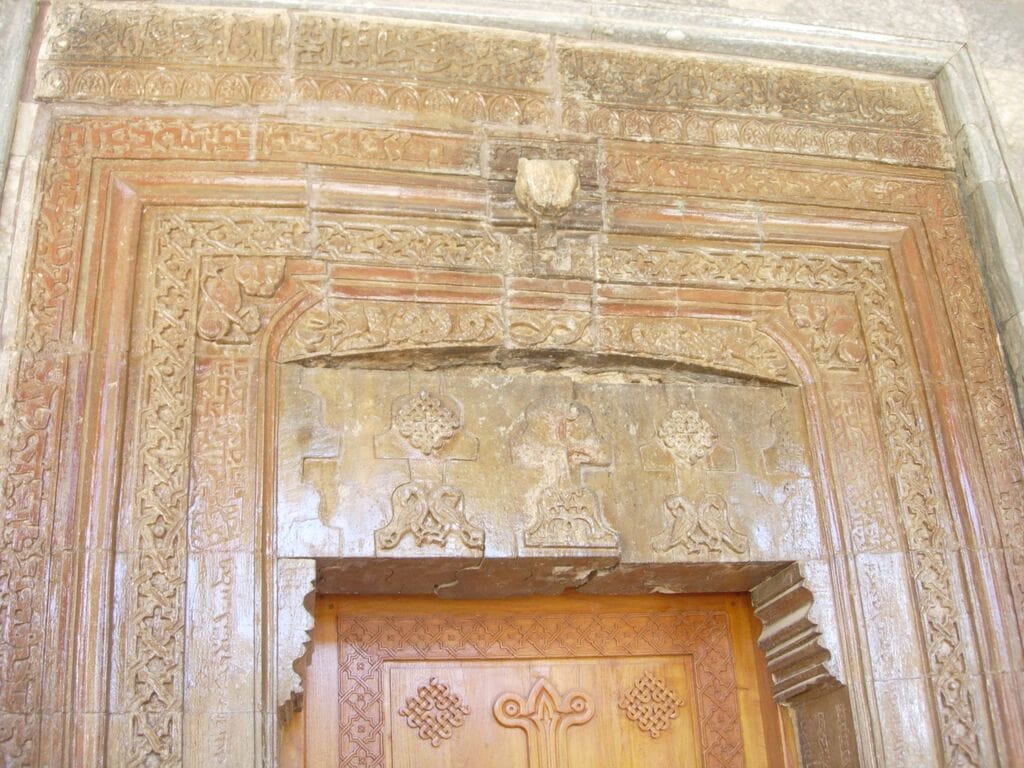 Doorway to the shrine showing arabesques and Arabic calligraphy. Photo (c) Suzanne Bott, 2009. Used with permission.