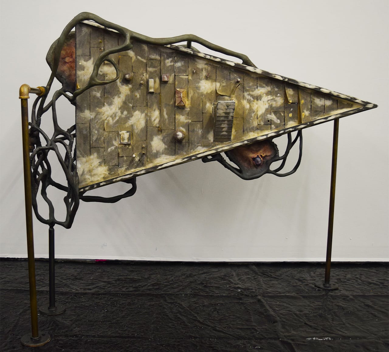 Dora Budor, "Slow Ticking of the Callous Mind" (2015), screen-used miniature rooftop from 'Batman Returns' (1992), steel armature, epoxy clay, infected silicone prosthetics, acrylic polymer with pigment suspension, sfx and weathering paint, and assorted metal hardware