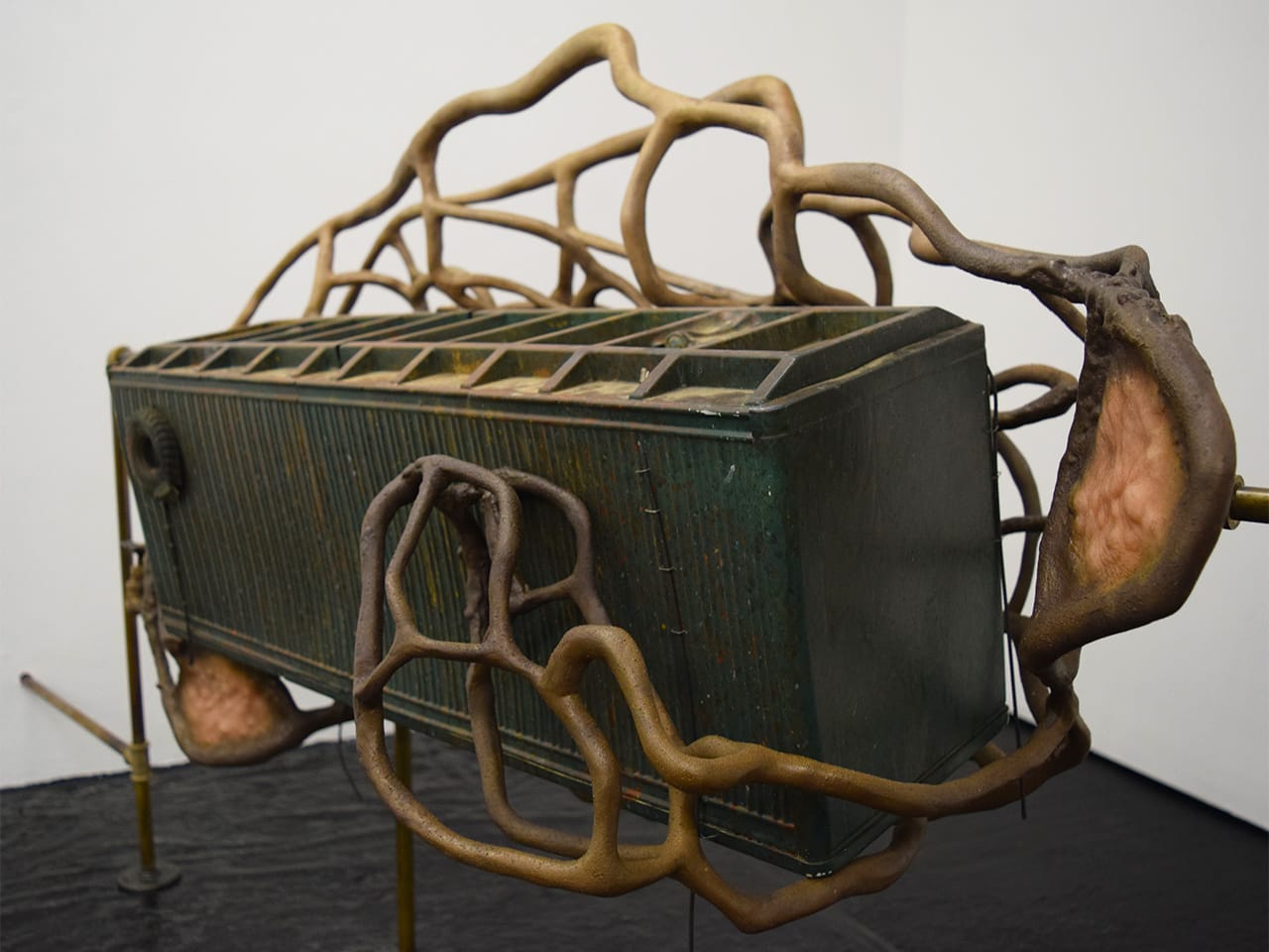 Detail of Dora Budor, "Our Children Will Have Yellow Eyes" (2015), screen-used miniature rooftop from 'Johnny Mnemonic' (1995), steel armature, epoxy clay, infected silicone prosthetics, acrylic polymer with pigment suspension, sfx and weathering paint, and assorted metal hardware