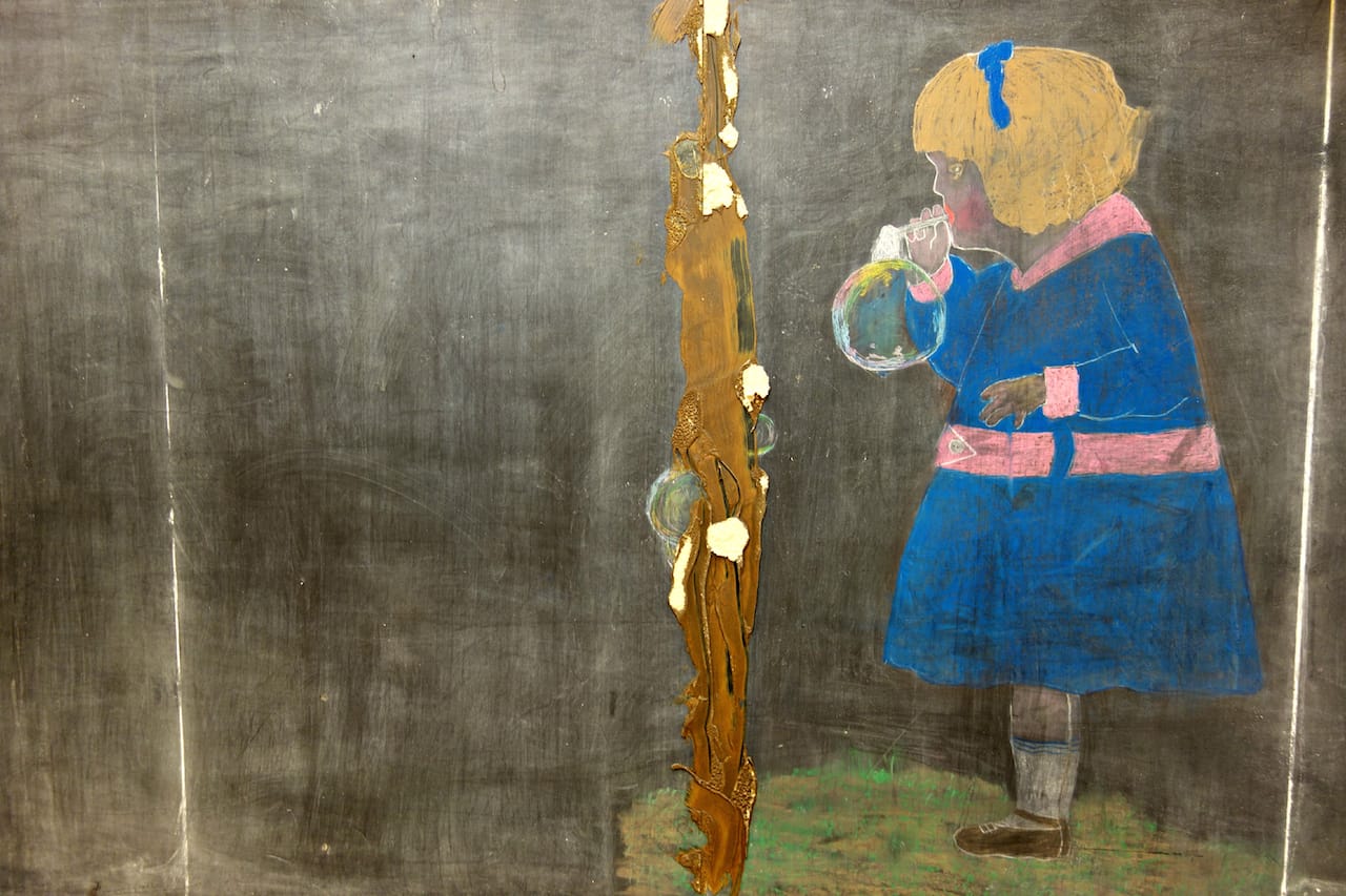 A 1917 chalkboard drawing of a girl blowing bubbles discovered last June (photo by the author for Hyperallergic)