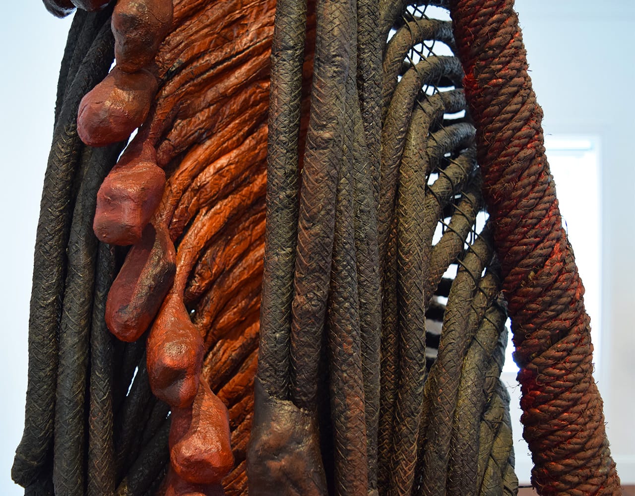 Detail of Françoise Grossen, "Metamorphosis IV (7)" (1987–90), manila, paper, plastic, acrylic paint (all photos by the author for Hyperallergic)