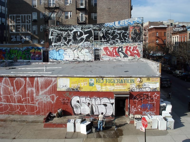 Graffiti tags and a handpainted sign in New York City