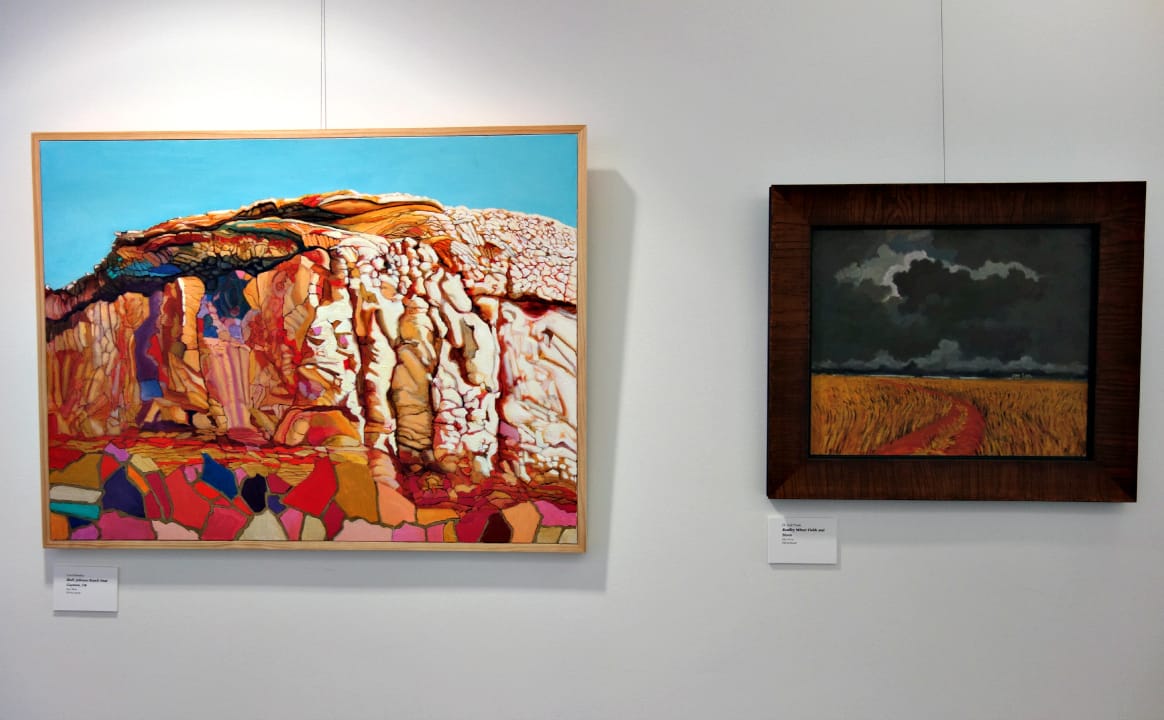 Carol Beesley, "Bluff, Johnson Ranch, Near Guymon, OK," oil on canvas; O. Gail Poole, "Bradley Wheat Fields and Storm," oil on canvas (photo by the author for Hyperallergic)