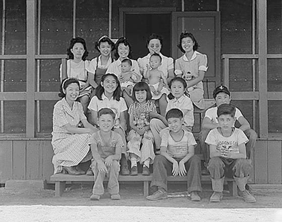 Dorothea Lange, "Manzanar, CA, July 1, 1942" (1942). Orphans from a San Francisco institution who had recently been brought to the camp’s Childrens' Village. Lilian Matsumoto, a University of California graduate (top row in sunglasses) and her husband were staff members who helped oversee children from mostly three West Coast orphanages that were specifically for children of Japanese ancestry (photographed by Dorothea Lange, WRA, courtesy the National Archives [Archives Identifier 538187])