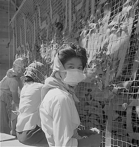 Dorothea Lange, "Manzanar, CA, July 1, 1942" (1942). Women making camouflage nets for the War Department. One of several War and Navy Department projects carried out by incarcerees in American concentration camps (photographed by Dorothea Lange, WRA, courtesy the National Archives [Archives Identifier 538116])