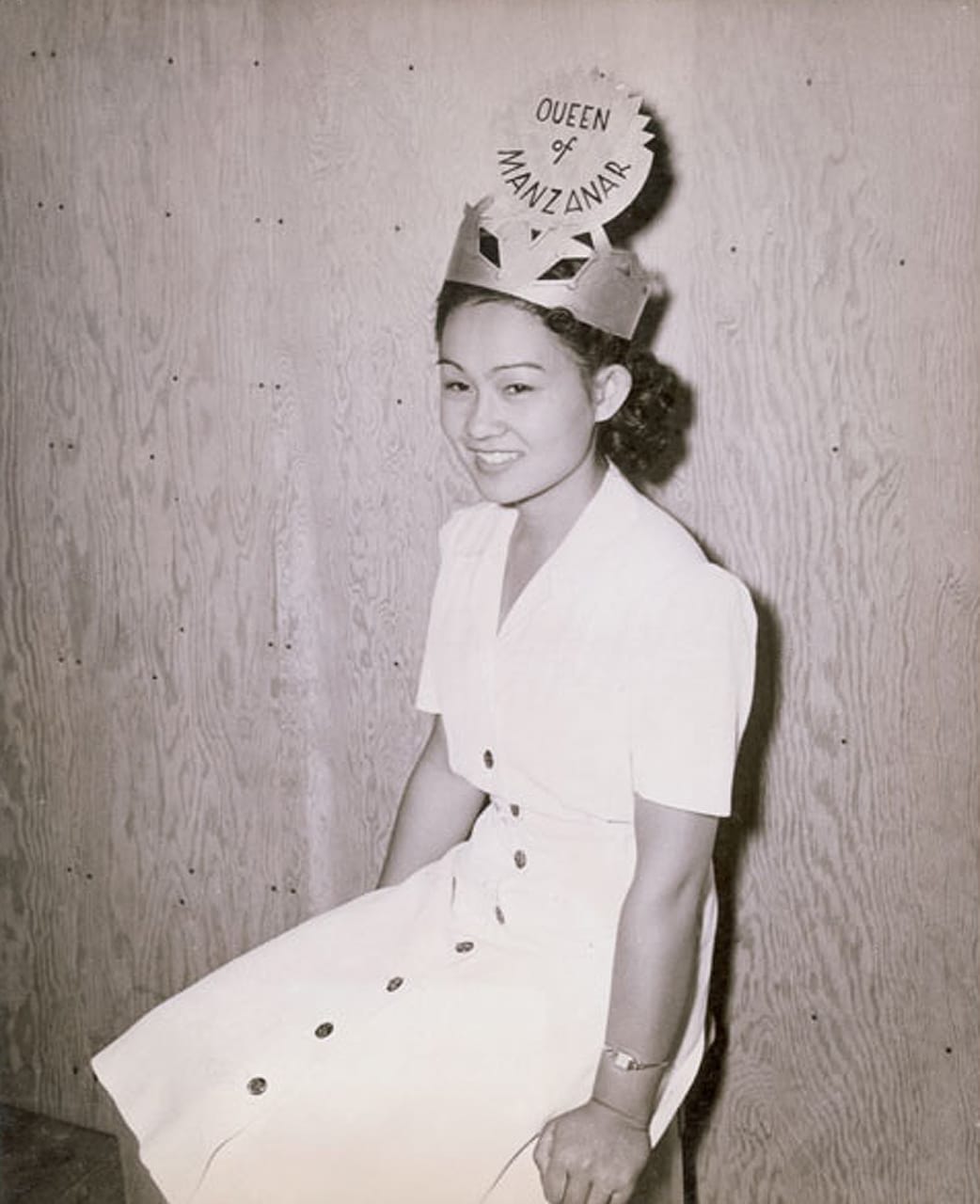 Jack Iwata, "Queen Manzanar" (ca. 1942-1943), Manzanar incarceration center, Manzanar, California. Margie Midori Shimizu Hirashimal, the Queen of Manzanar, wearing a handmade crown. Iwata was Miyatake's assistant at both his Little Tokyo studio and, upon forced removal, Miyatake's in-camp studio in Ironing Building Block 30. After the war, he went on to work for Kyodo News (http://www.kyodonews.jp/english/), Japan's largest news agency, and made a name for himself for his photographs of people like Elizabeth Taylor, Elvis Presley, and John Wayne (photographed by Jack Iwata, from the Jack Iwata Collection, JANM, courtesy of the Japanese American National Museum [93.102.133]) 