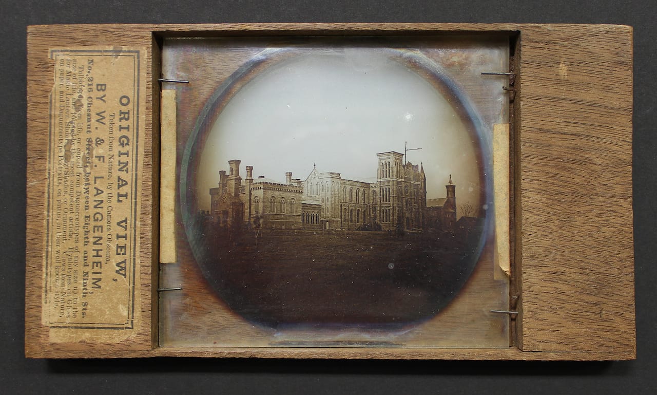 Lantern slide photograph on glass in wood mount of Smithsonian Institution Building (Smithsonian Castle) under construction, by William Langenheim and Frederick Langenheim of Philadelphia (1850) (courtesy Smithsonian Castle Collection)