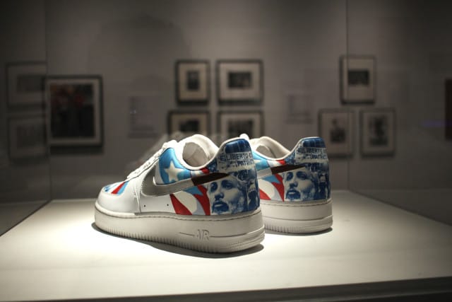Miguel Luciano, “Machetero Air Force One’s (Filiberto Ojeda Uptowns” (2007) vinyl and acrylic on sneakers, 11 x 4 x 4 ½ inches
