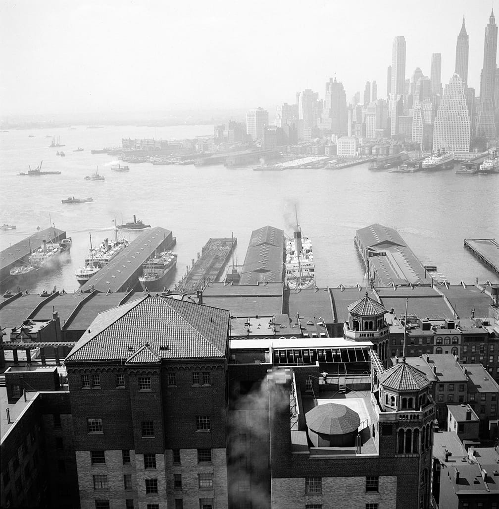View from the Hotel St. George in Brooklyn Heights (once NYC's largest hotel) showing piers on the Brooklyn shore jutting into the East River with views of lower Manhattan. (April 3, 1935)