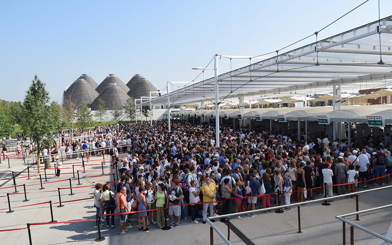 Lines of people waiting to pass through the security checkpoint at one of the entrances to Expo Milano