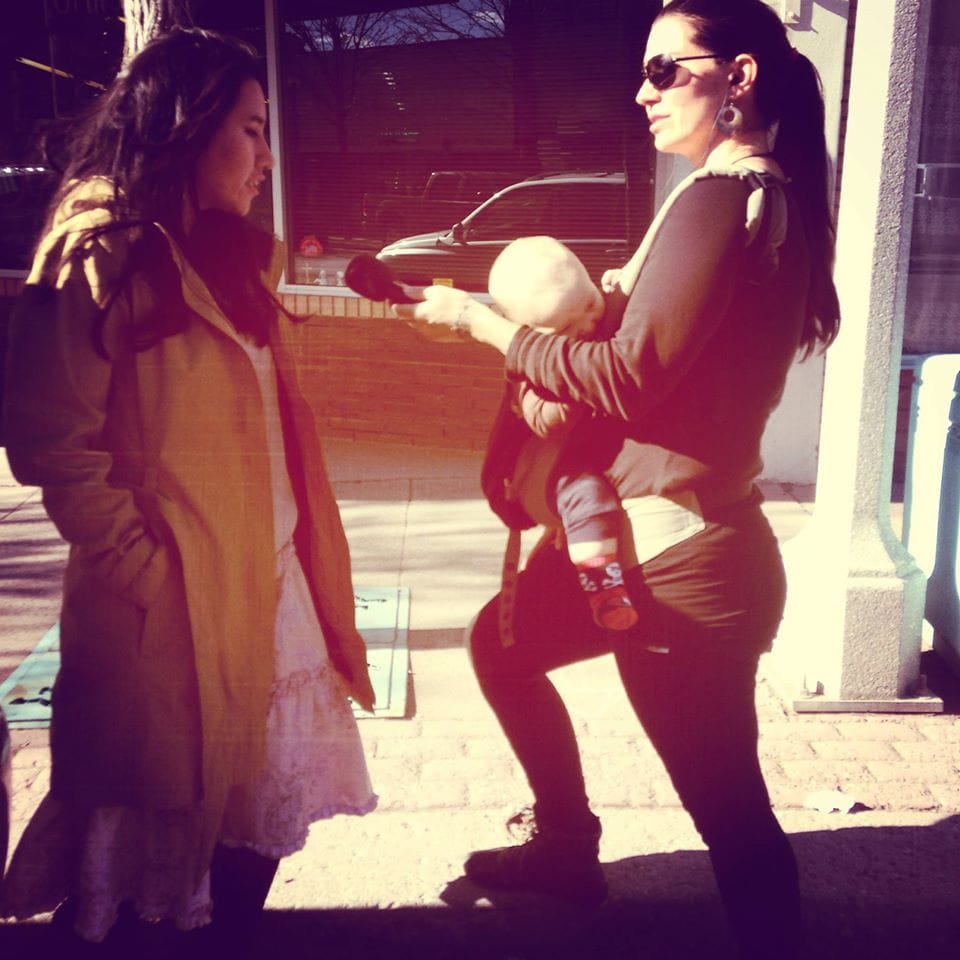 Ginger interviewing an activist from "Journey for Existence" (photo by Angel Mills)