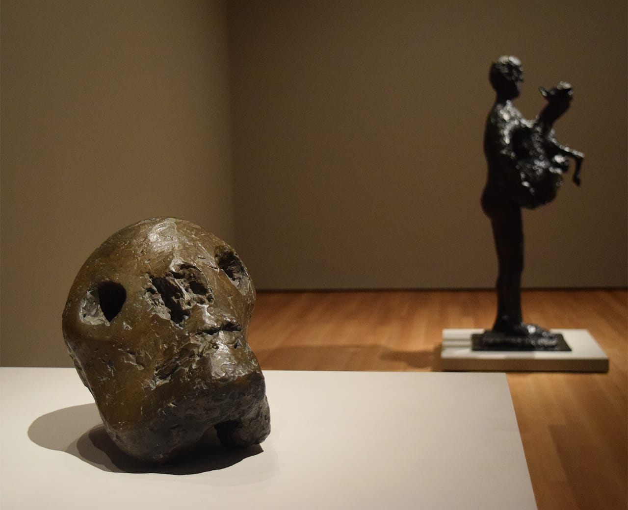 Installation view of 'Picasso Sculpture' at the Museum of Modern Art with Pablo Picasso's "Death's Head" (1941) at left and "Man with Lamb" (1943) at right