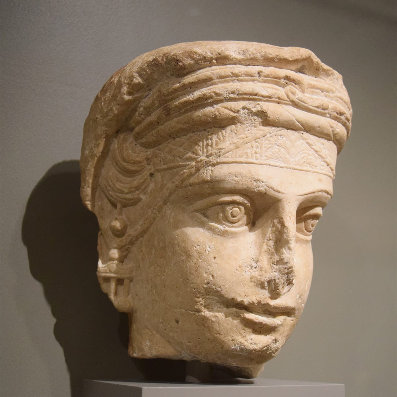 A limestone sculpture of the head of a woman from Palmyra, Syria (ca. 150 BCE) in one of Morgan Great Hall's new antiquities galleries