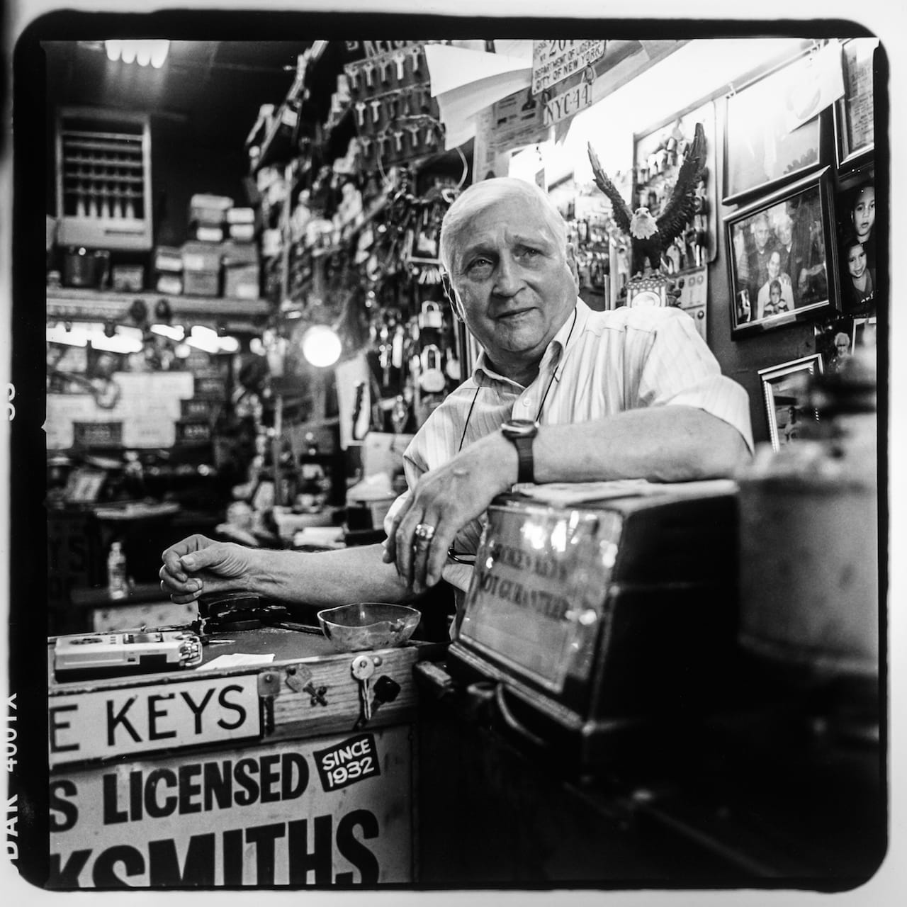 Raymond Herskovits inside of his miniature storefront, Mel's Locksmiths at 4 East 170th Street. Raymond is a third generation locksmith; his grandfather first opened the shop in 1932. He no longer resides in the Bronx, but commutes six days a week from his home in New Jersey to open his shop. Photo taken August 2015 by David “Dee” Delgado/Bronx Photo League. 
