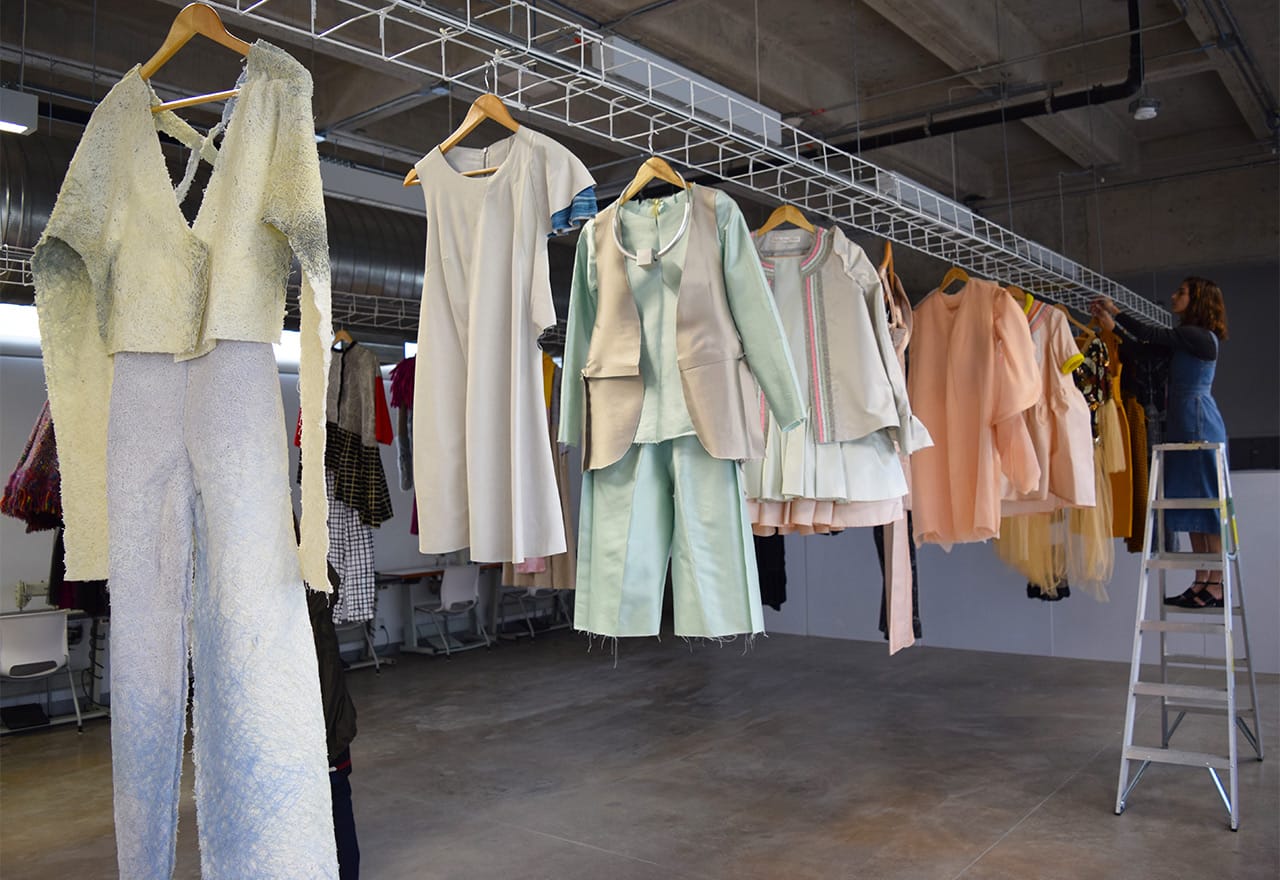 Student work hanging in one of CENTRO's textile and fashion design classrooms