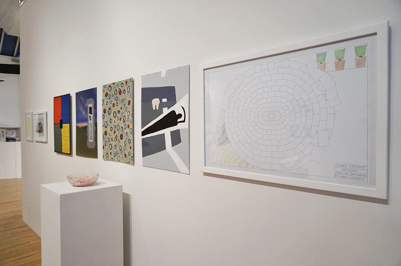 Work by Harold Wayne Nichols, including "A World Without Prisons" (2015), ink and colored pencil on paper, 32 x 22 in, on far right (click to enlarge)