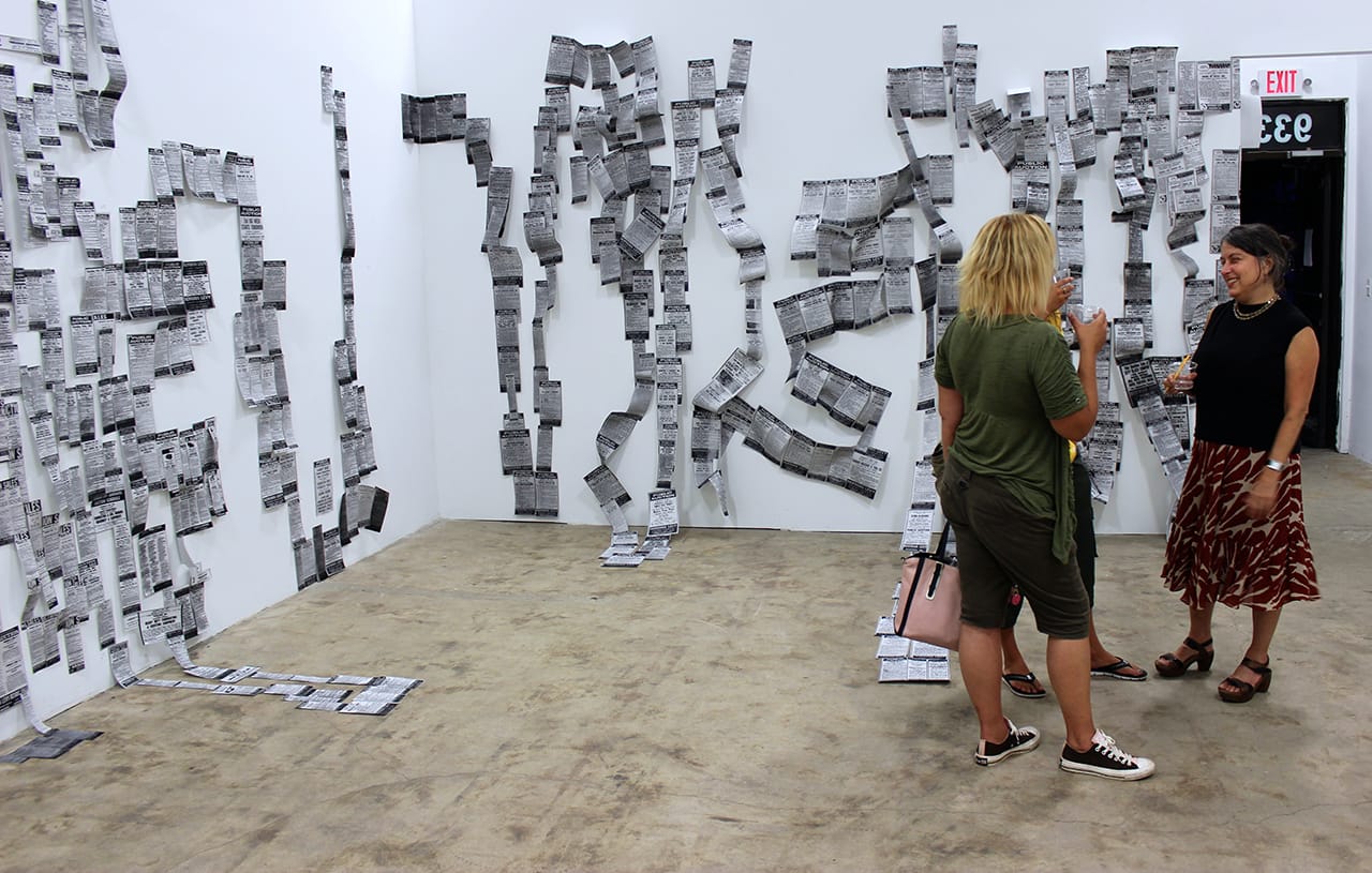 Installation view of 'Fate of the Machinery' with the auction listings laid out in a complete chronology over decades, forming a history of objects sold at the Levy family auction house.