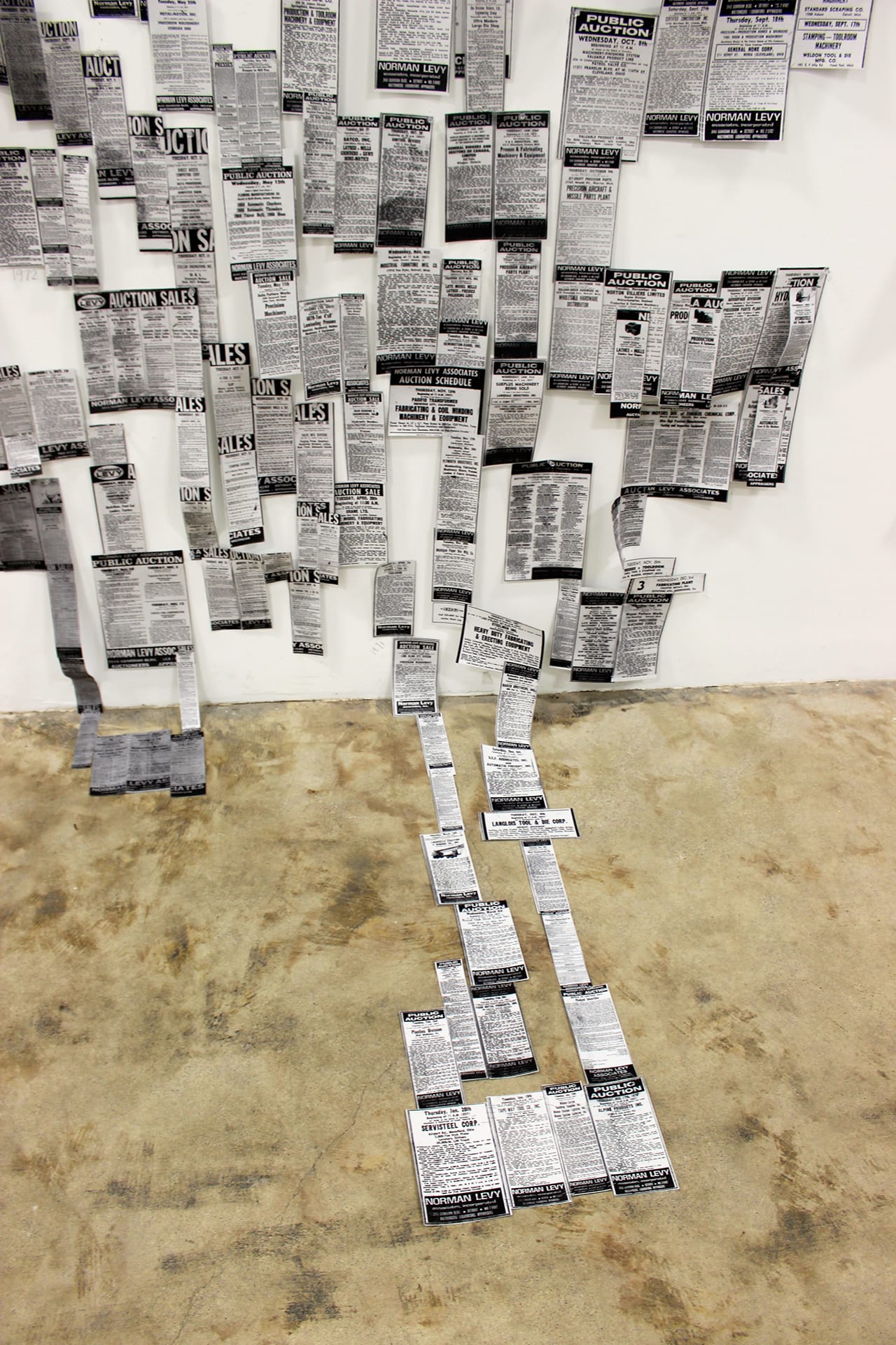 Installation view of 'Fate of the Machinery' with the auction listings laid out in a complete chronology over decades, forming a history of objects sold at the Levy family auction house.