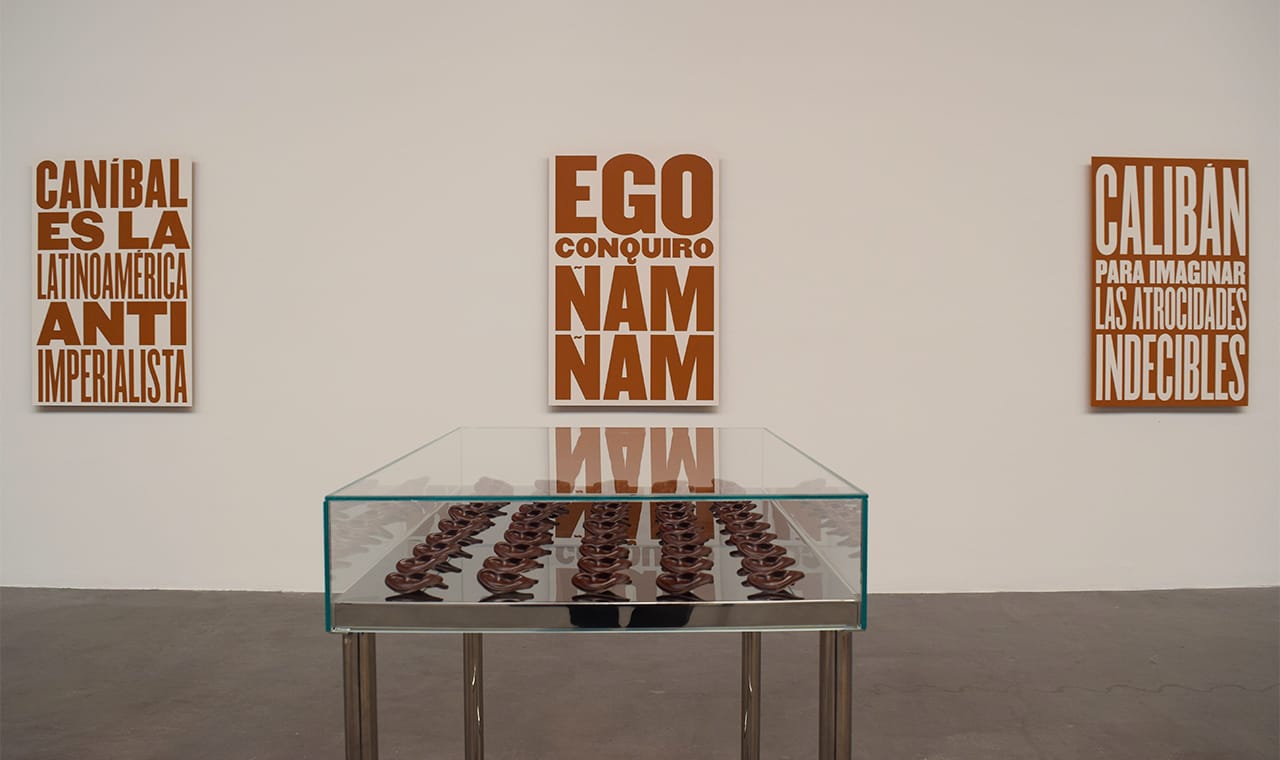 Installation view of Minerva Cuervas's 'Feast and Famine' with "Like a Tzompantli" (2015), chocolate ears in showcase and polycarbonate molds, in the foreground