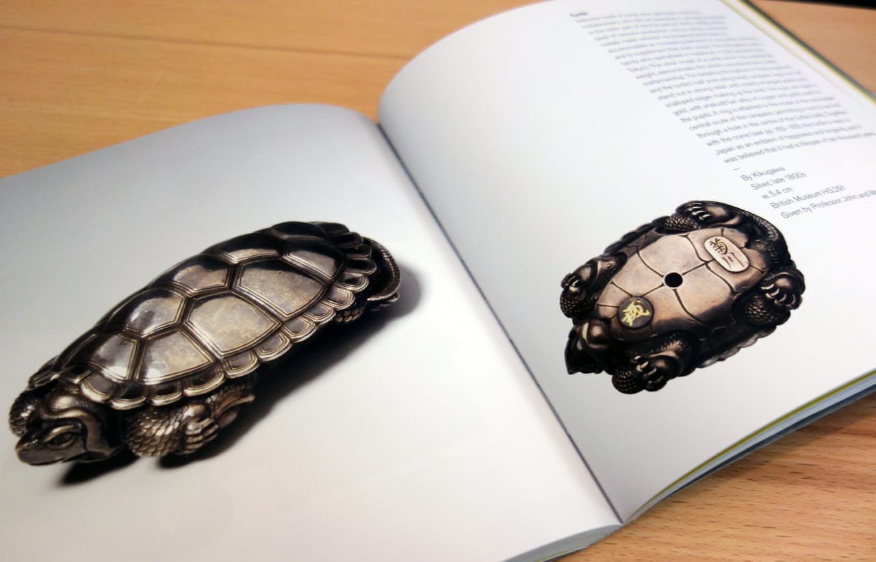 Pages from 'Netsuke: 100 Miniature Masterpieces from Japan' (photo of the book for Hyperallergic)