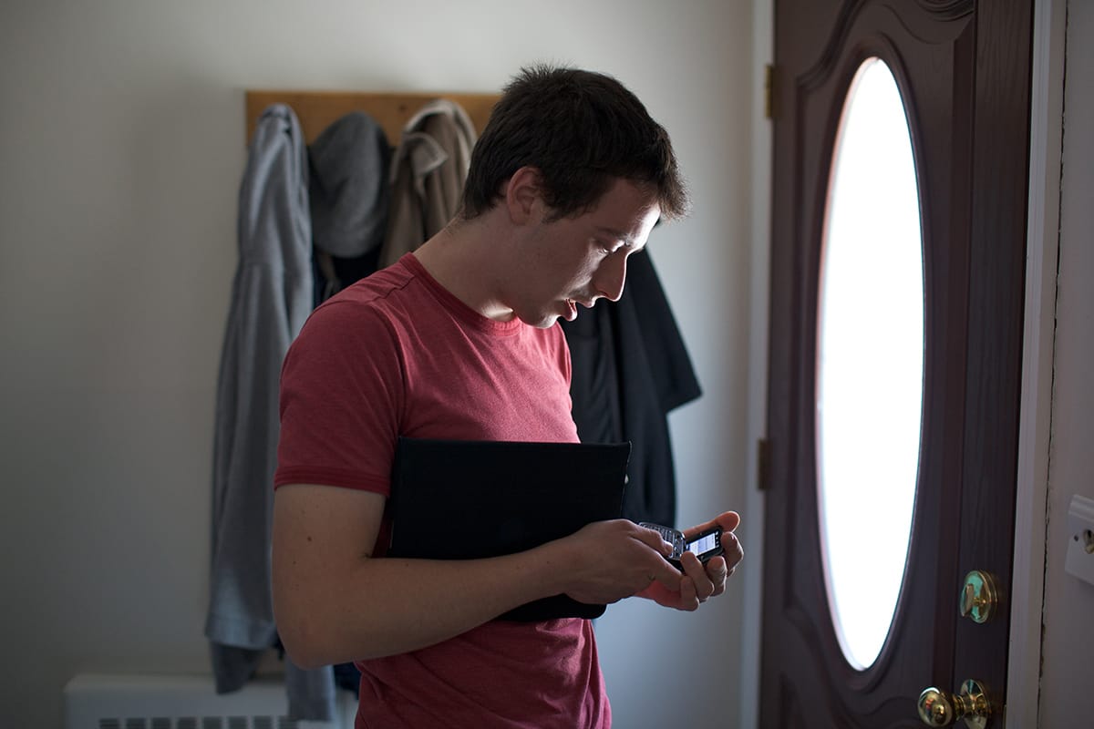 Andrew S. at home, in his bedroom.